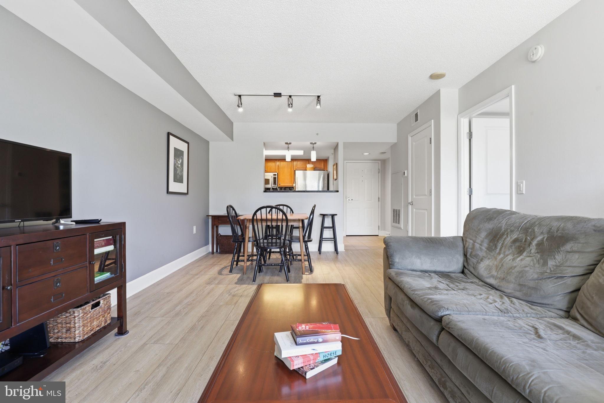 11800 Sunset Hills Road, Unit 218 Reston, VA 20190 - Photo 17 of 38 a living room with furniture and a flat screen tv