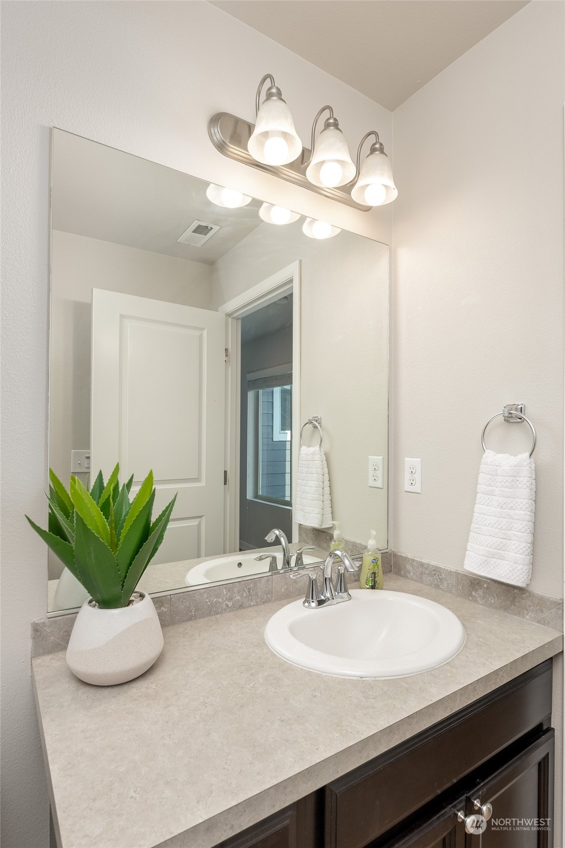 1544 Craig Road Southeast Olympia, WA 98501 - Photo 22 of 31 a bathroom with a sink a mirror and vanity