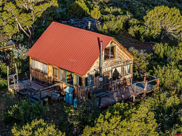 a view of a house with brick walls and deck