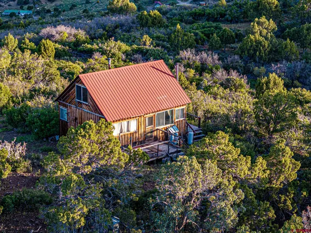 a view of a house with a yard and garden