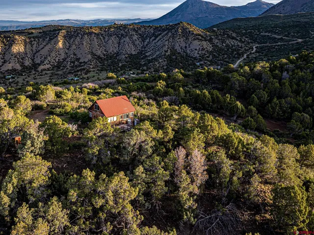 a view of house with yard and outdoor seating