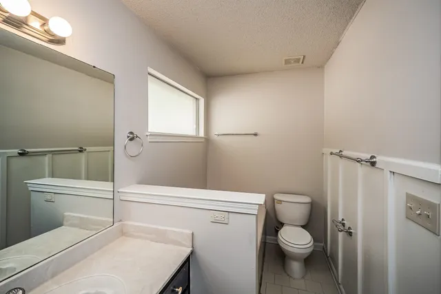 a bathroom with a toilet a sink and shower