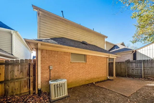 a view of a blue house with a outdoor space