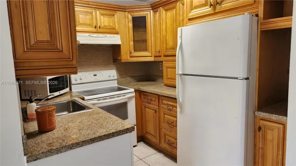 a kitchen with a refrigerator stove and sink