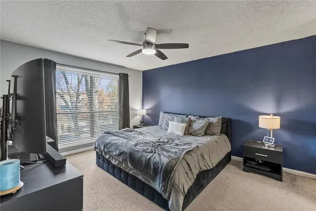 a bedroom with a bed and a lamp next to a window