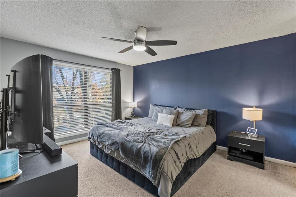 2657 Lenox Road Northeast, Unit L 163 Atlanta, GA 30324 - Photo 12 of 34 a bedroom with a bed and a lamp next to a window