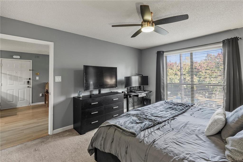 2657 Lenox Road Northeast, Unit L 163 Atlanta, GA 30324 - Photo 13 of 34 a bedroom with a bed and a flat screen tv