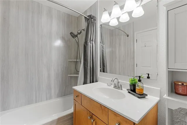 a bathroom with a sink a mirror and a shower curtain