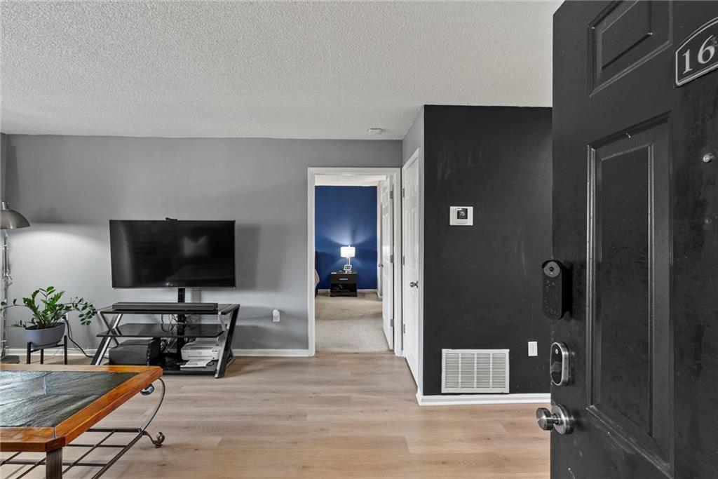 2657 Lenox Road Northeast, Unit L 163 Atlanta, GA 30324 - Photo 2 of 34 a living room with furniture and a flat screen tv
