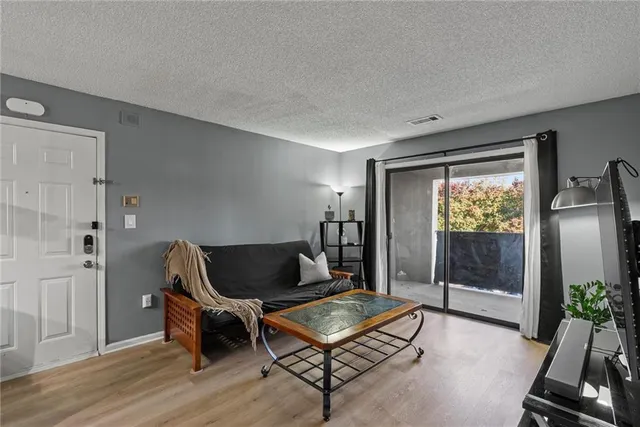 a living room with furniture gym equipment and glass door