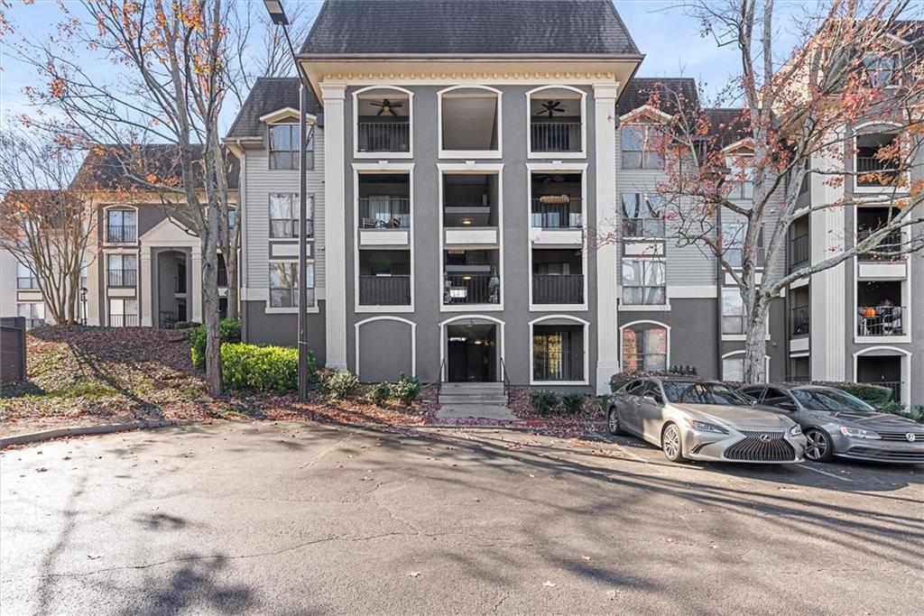2657 Lenox Road Northeast, Unit L 163 Atlanta, GA 30324 - Photo 31 of 34 a front view of a building with lot of cars and trees