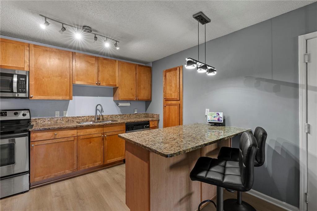 2657 Lenox Road Northeast, Unit L 163 Atlanta, GA 30324 - Photo 6 of 34 a kitchen with a center island appliances and cabinets