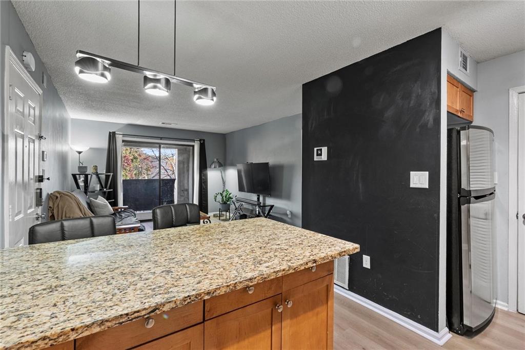 2657 Lenox Road Northeast, Unit L 163 Atlanta, GA 30324 - Photo 8 of 34 a view of living room with granite countertop furniture and fireplace