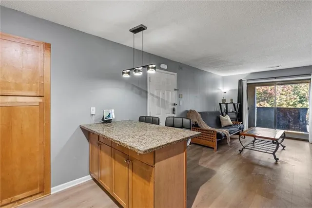 a living room with dining table and wooden floor