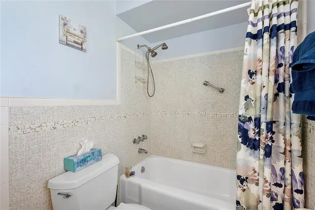 a bathroom with a bathtub and shower