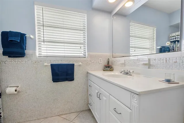 a bathroom with a sink a vanity and a mirror