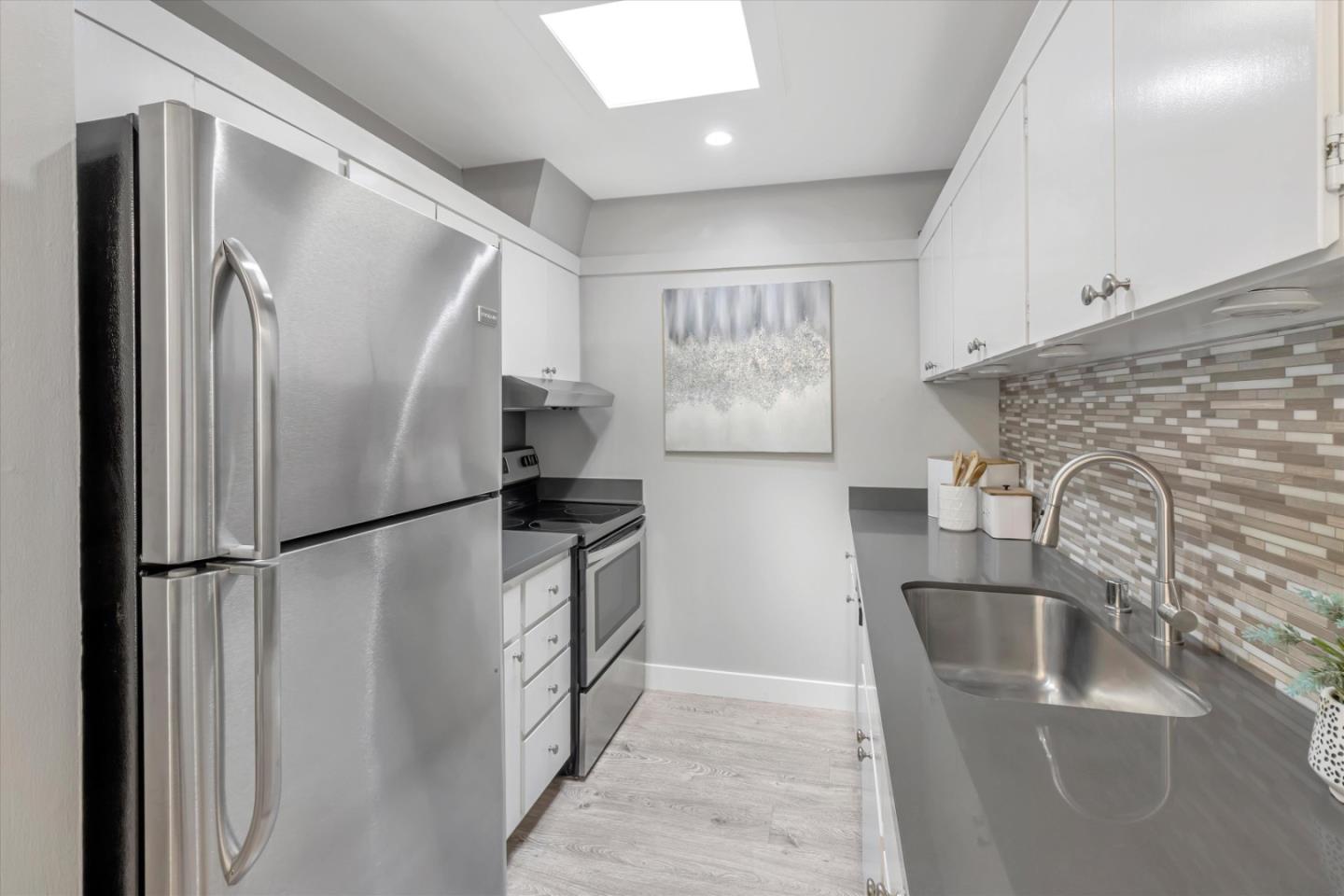 500 West Middlefield Road, Unit 100 Mountain View, CA 94043 - Photo 16 of 47 a kitchen with stainless steel appliances a refrigerator and a sink