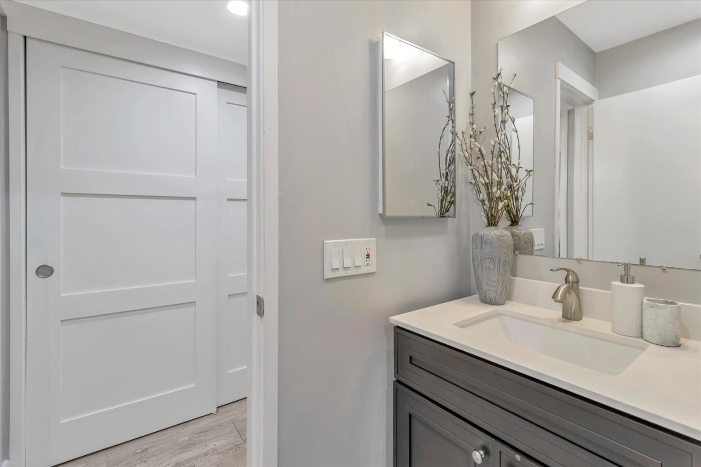500 West Middlefield Road, Unit 100 Mountain View, CA 94043 - Photo 22 of 47 a bathroom with a granite countertop sink and a mirror