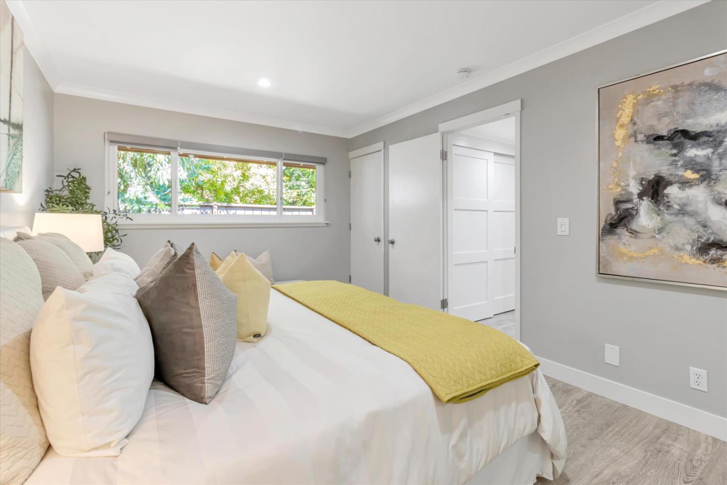 500 West Middlefield Road, Unit 100 Mountain View, CA 94043 - Photo 25 of 47 a bed sitting in a bedroom next to a window
