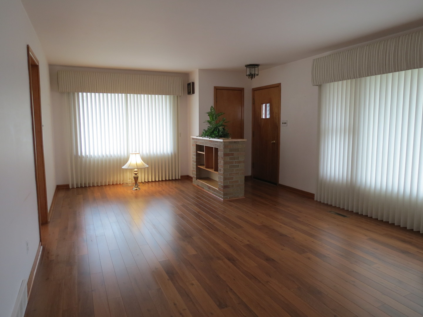 120 East 6th Street Momence, IL 60954 - Photo 10 of 26 an empty room with wooden floor and windows
