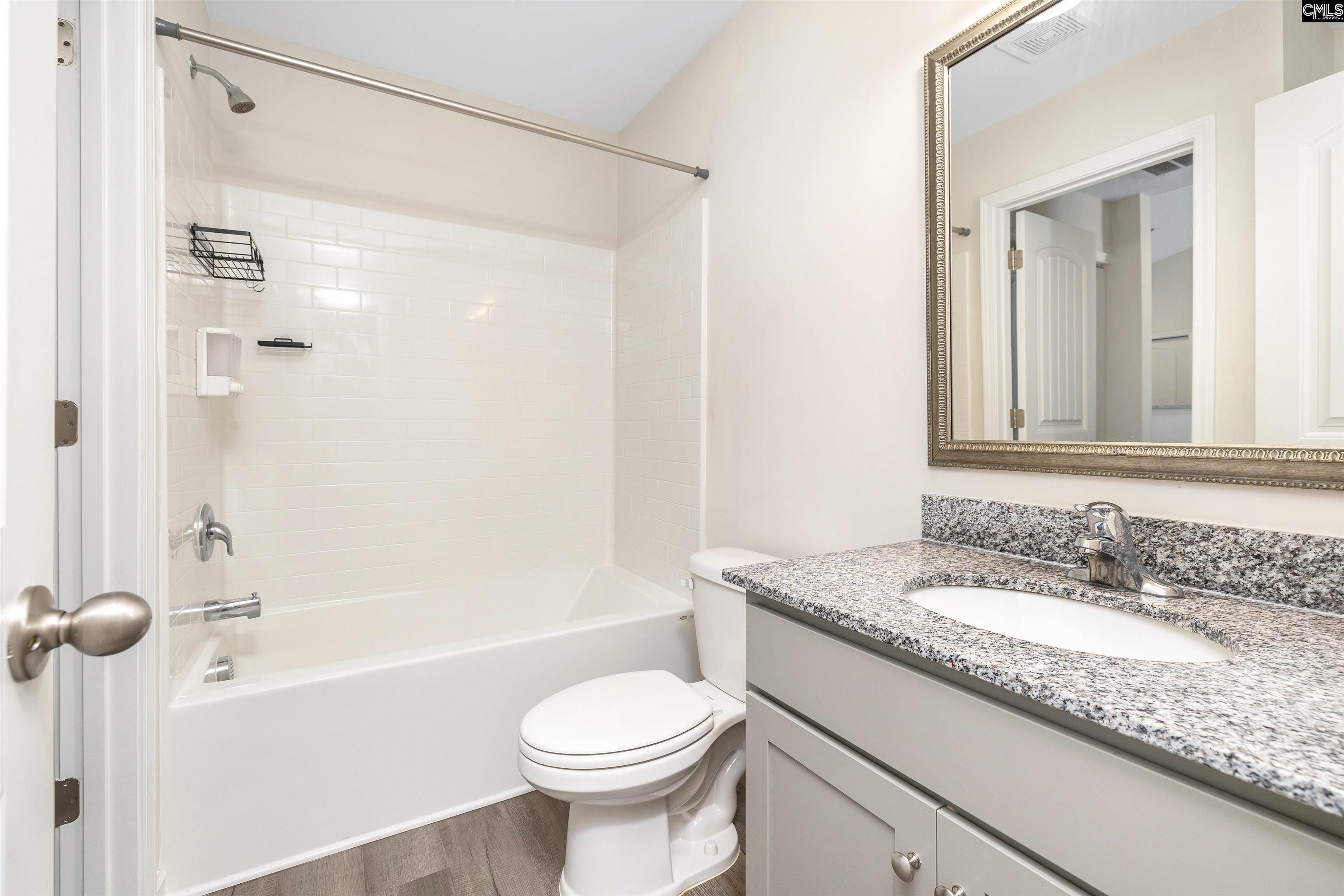 2157 Still Pointe Drive Sumter, SC 29154 - Photo 9 of 25 a bathroom with a granite countertop sink toilet and shower