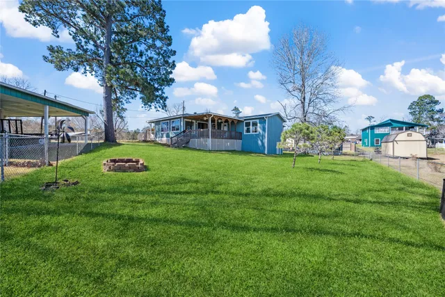 a view of a house with a big yard and garden