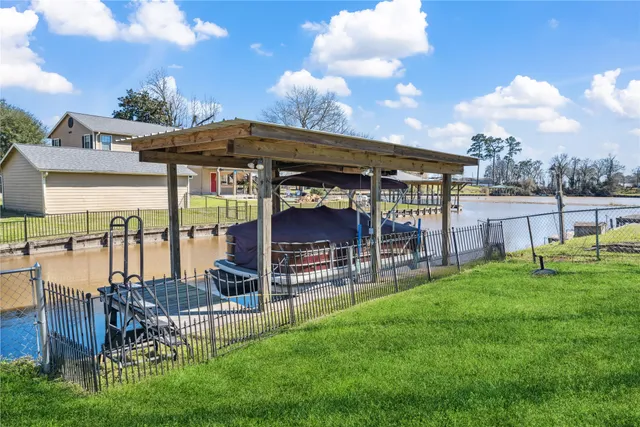 a view of a chair and table in backyard of the house