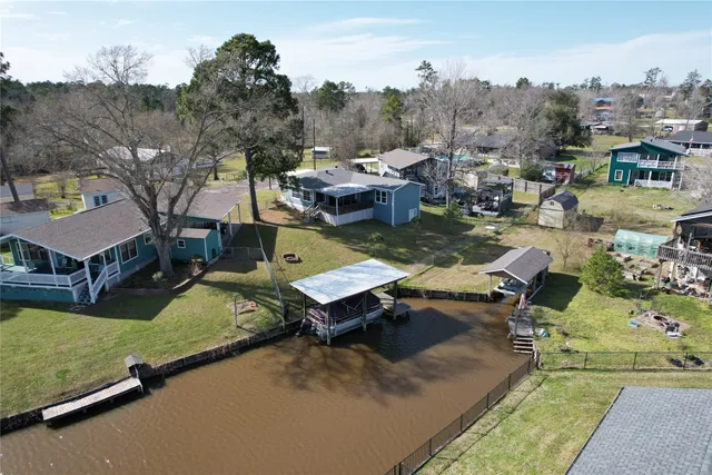 a view of a house with pool and a yard