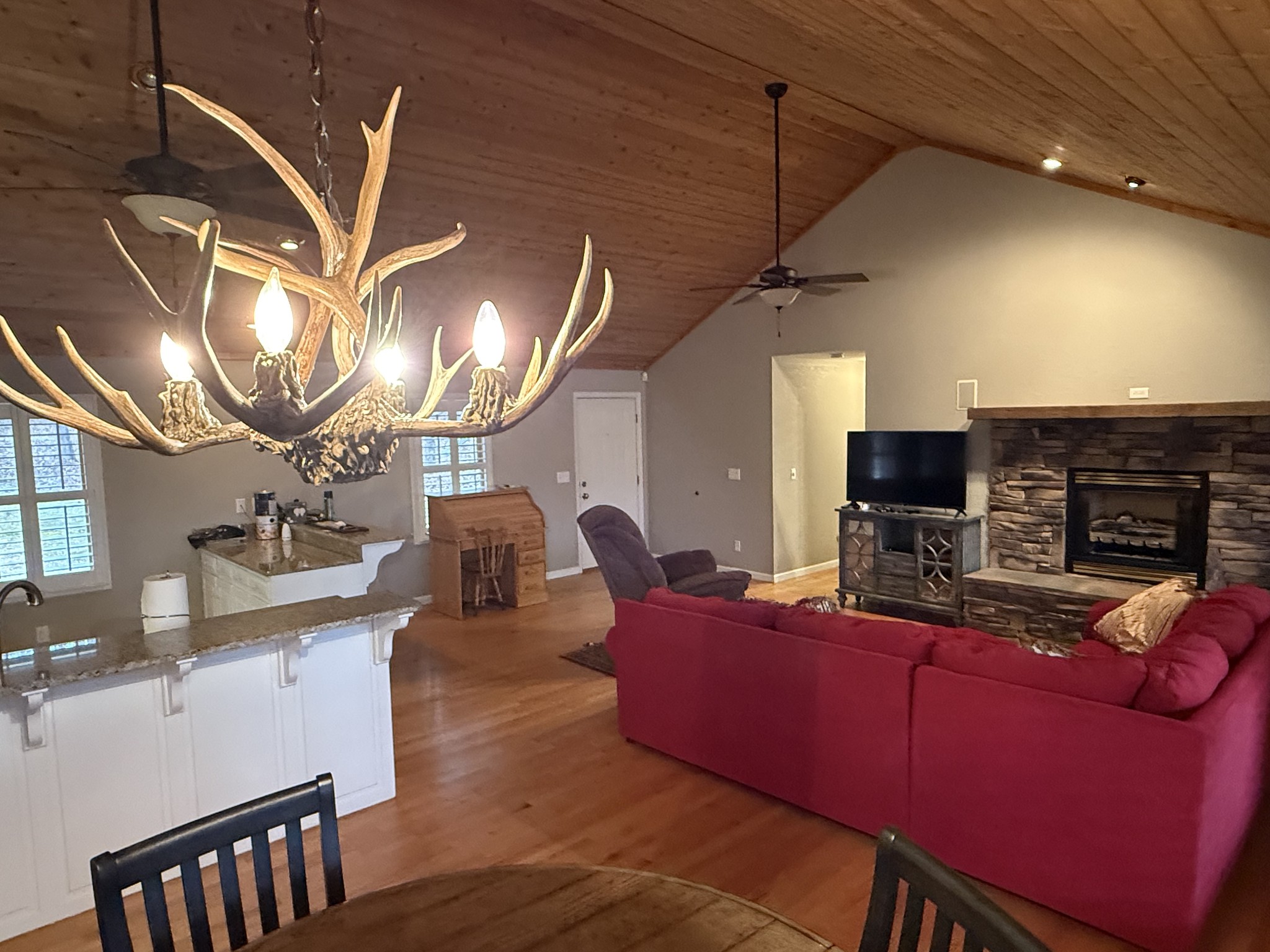 107 Chickory Lane Monteagle, TN 37356 - Photo 11 of 34 a living room with furniture a fireplace and a chandelier