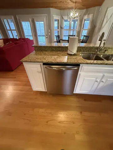 a large kitchen with lots of counter space a sink and dishwasher