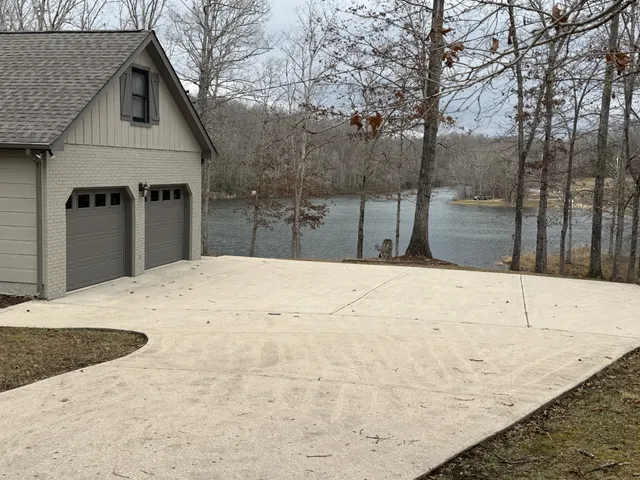 a backyard of a house with lots of tall trees