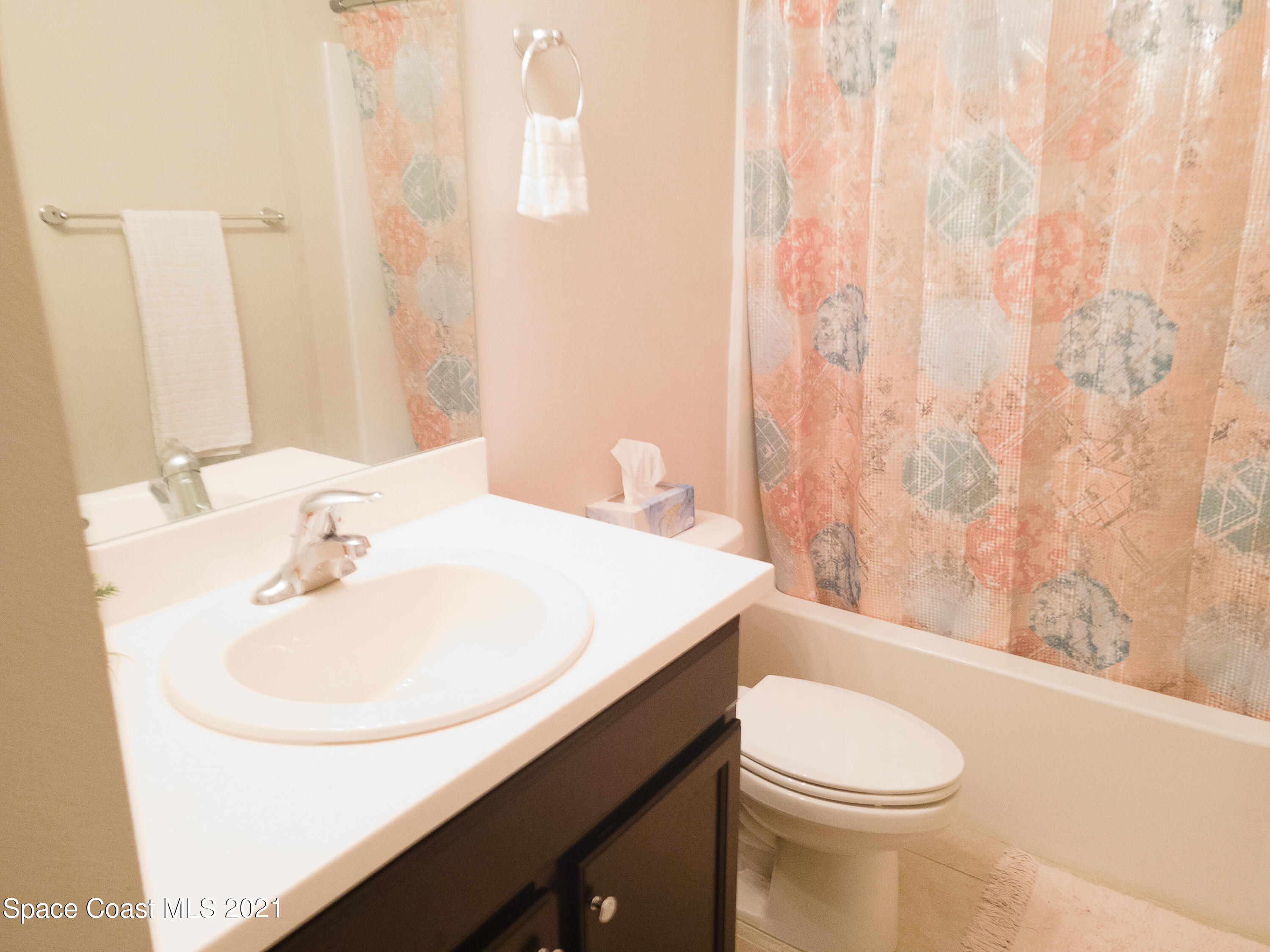 1525 Talbott Street Palm Bay, FL 32909 - Photo 14 of 31 a bathroom with a sink a toilet and shower curtain