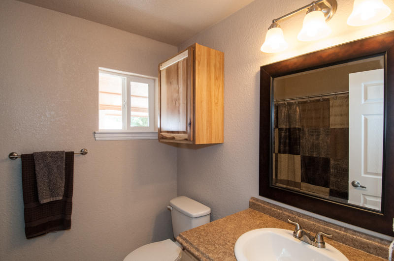 22014 Lone Tree Road Anderson, CA 96007 - Photo 15 of 19 a bathroom with a granite countertop toilet sink and mirror