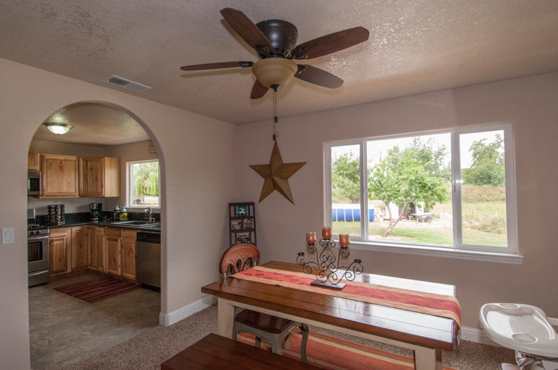 22014 Lone Tree Road Anderson, CA 96007 - Photo 8 of 19 a room with furniture and a chandelier