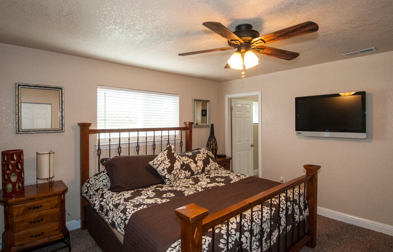 22014 Lone Tree Road Anderson, CA 96007 - Photo 9 of 19 a bed room with furniture and a flat screen tv