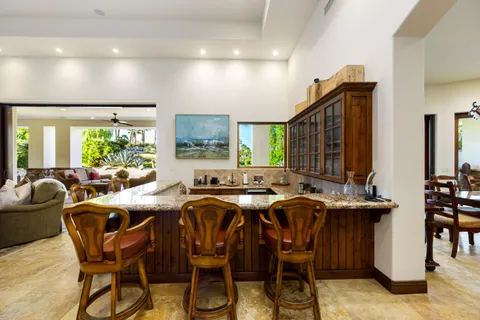 a large kitchen with stainless steel appliances granite countertop a lot of counter space and a sink