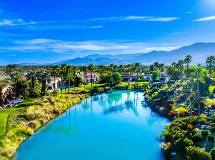 a living room with fireplace furniture and a large window