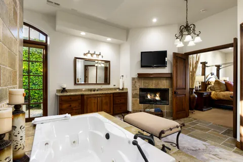 a bathroom with a double vanity sink a toilet and shower