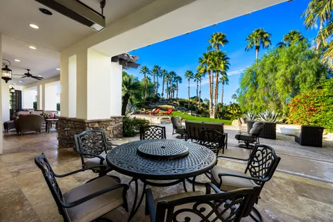 a view of a house with swimming pool and sitting area
