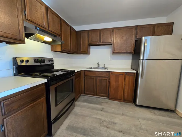 a kitchen with a sink appliances and cabinets