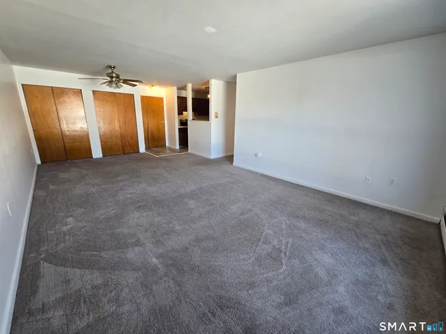 a living room with furniture and a large mirror