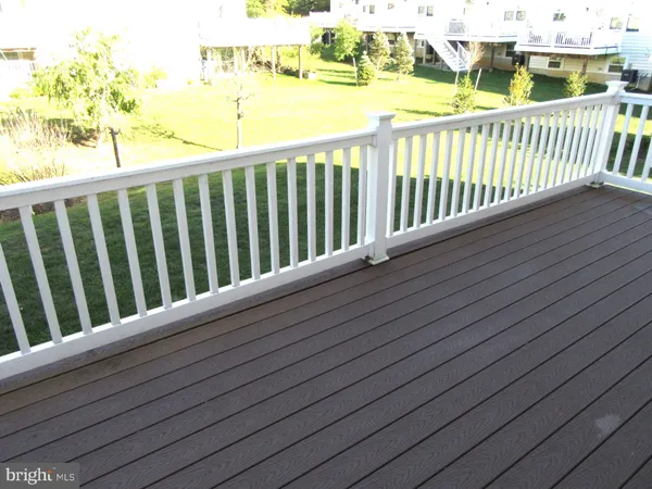 a view of a balcony with wooden floor