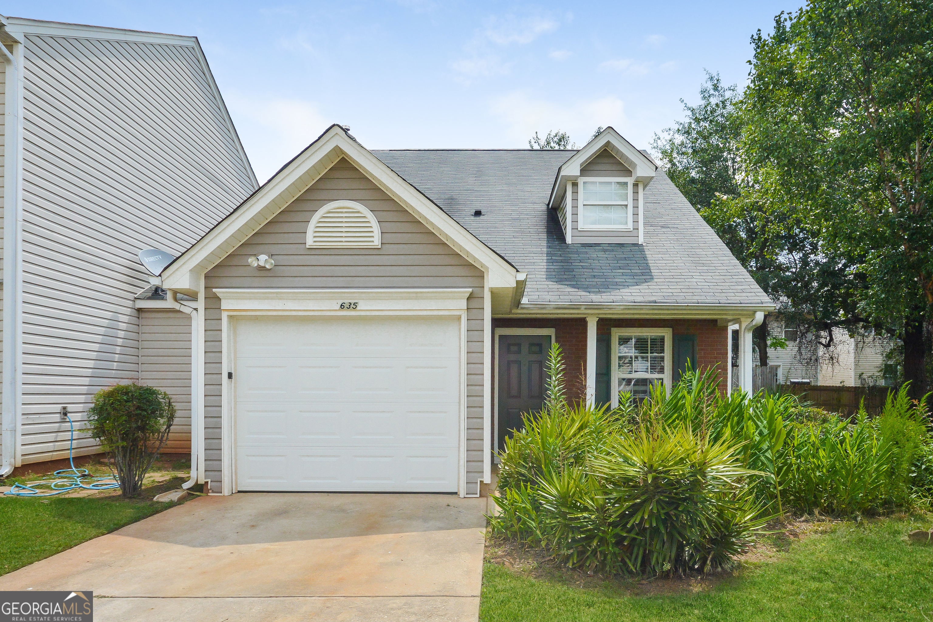 635 Lakeside Circle Covington, GA 30016 - Photo 1 of 1 a front view of a house with garden