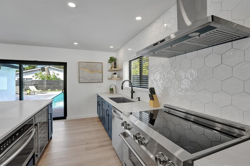 5501 Northeast 18th Terrace Fort Lauderdale, FL 33308 - Photo 11 of 56 a kitchen with stainless steel appliances granite countertop a sink and a stove
