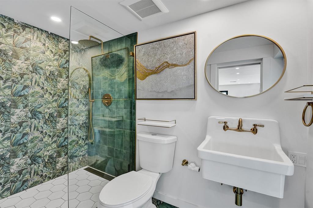 5501 Northeast 18th Terrace Fort Lauderdale, FL 33308 - Photo 12 of 56 a bathroom with a sink toilet and shower