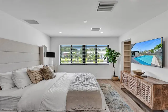 a bed sitting in a bedroom next to a window