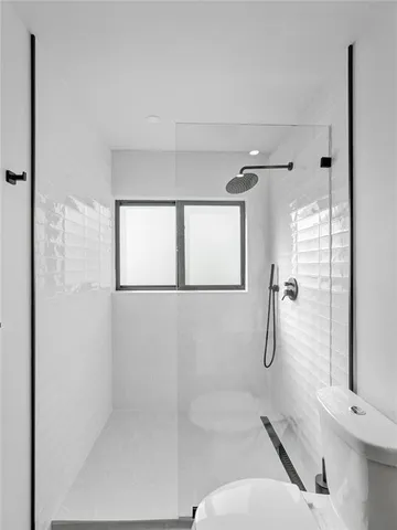 a living room with lots of furniture and view of kitchen