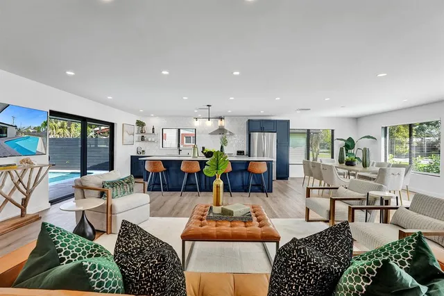 a kitchen with stainless steel appliances granite countertop a sink and a refrigerator