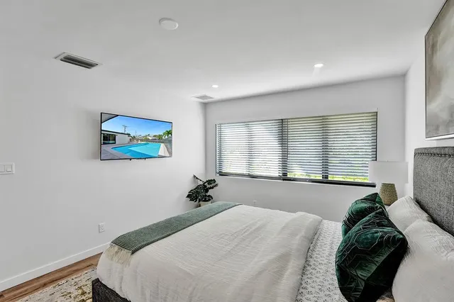 a bedroom with a bed and window