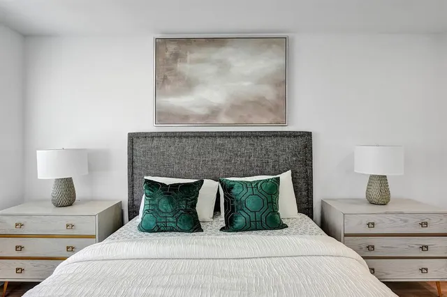 a bedroom with a large bed and a window